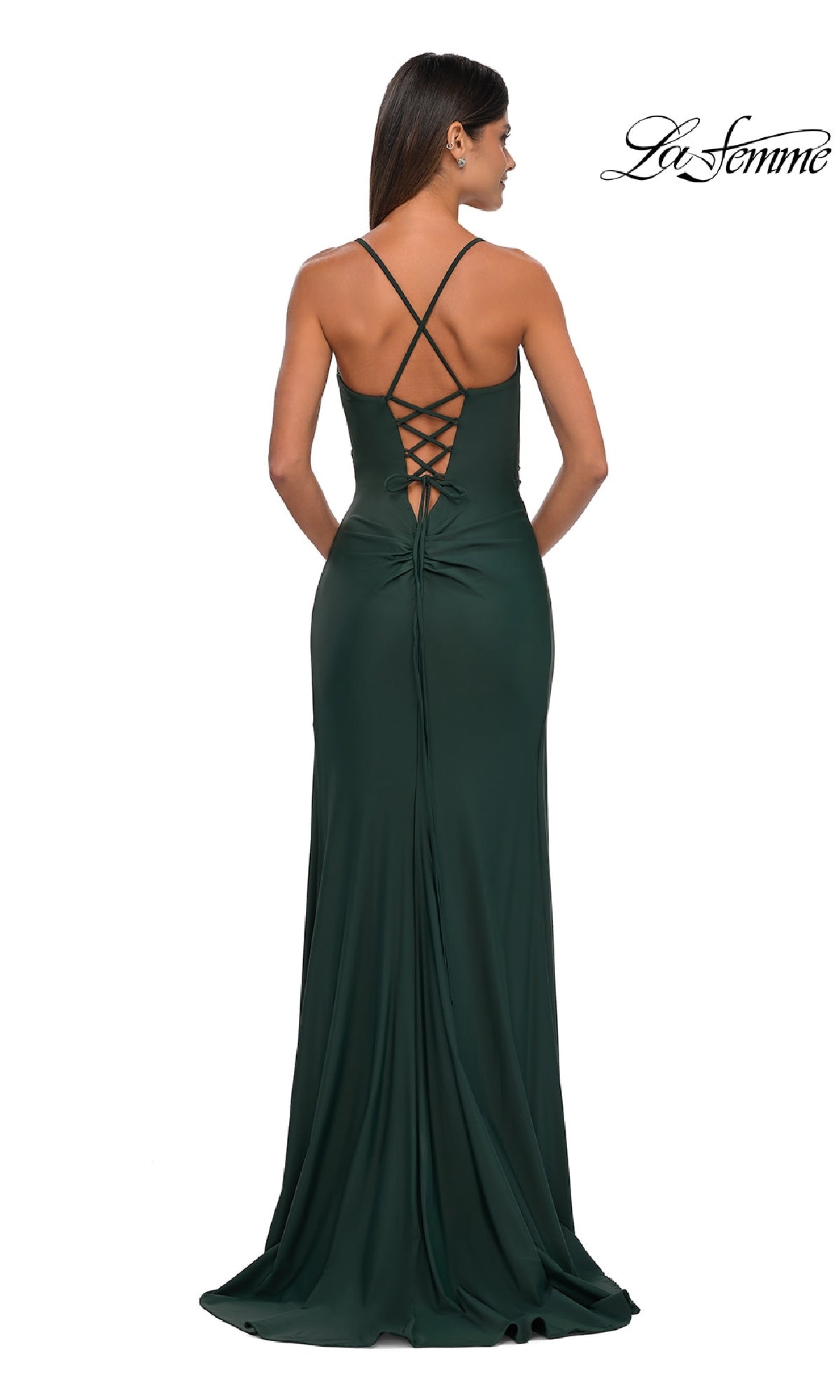 A woman wearing the La Femme 33103 Lace-Up Simple Long Prom Dress in dark green, featuring crisscross straps and a lace-up back, stands facing away from the camera.